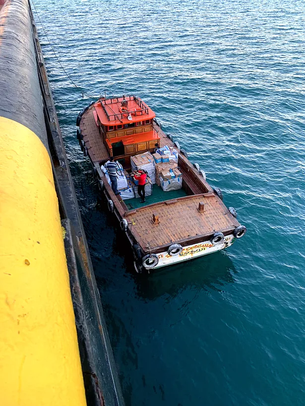 Zadix supply launch moored alongside a vessel, loaded with cargo